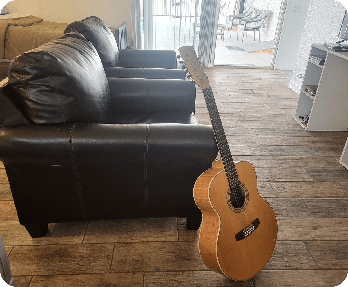 Guitar leaning on wooden floor